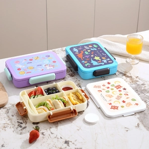 Three children's bento boxes with space, dinosaur, and bear themes in partitioned plastic