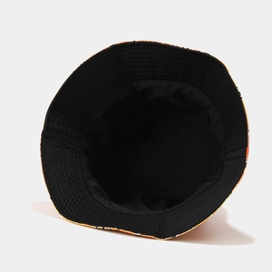 Detail view of tie-dye bucket hat showing black inner lining and paisley cotton fabric