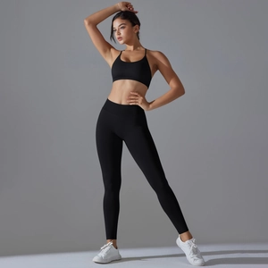 Detail of seamless black yoga set with high-waist leggings and V-back sports bra