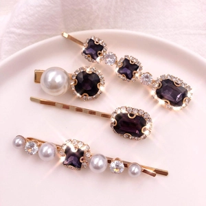 Detail of 4-piece vintage hair clip set with purple crystals and white pearls