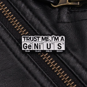 Macro shot of GeNiUS chemical element enamel pin on a black textured leather jacket