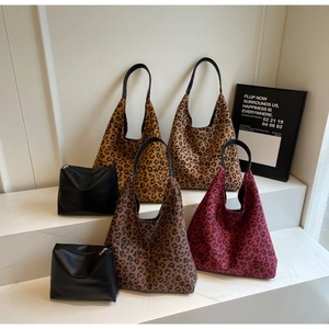 Leopard print tote bags in various colors displayed with matching black pouches