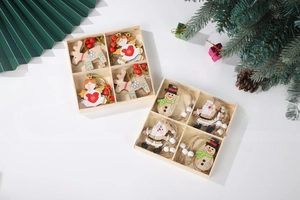Detail of wooden Christmas angel and reindeer ornaments in a divided storage box
