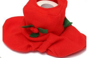 Close-up of red felt Santa toilet cover with green leaf detail and holiday stitching