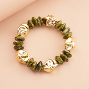 Detailed shot of retro gold beads and olive green marble texture acrylic beads on a bracelet
