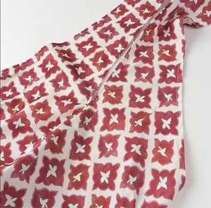 Detailed view of red and white geometric floral print fabric on high waist skirt set