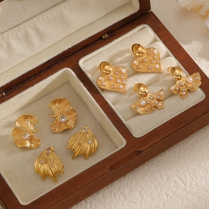 Elegant 18k gold-plated leaf earrings and heart studs set in a luxury wooden box