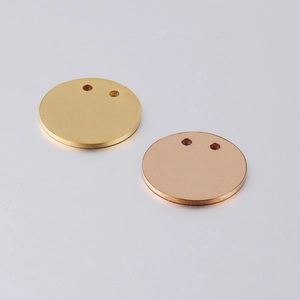 Close-up of 21mm mirror-polished gold and rose gold stainless steel dual-hole round tags