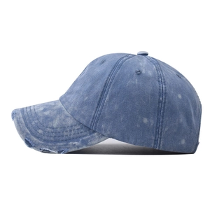 Classic washed denim baseball cap with distressed rip details shown from a side view