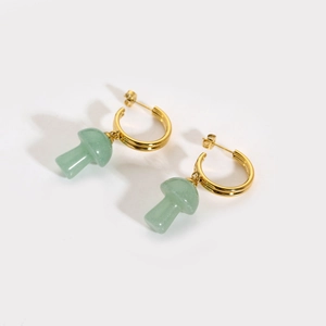 Detail of 18K gold-plated C-shape earrings featuring green stone mushroom pendants