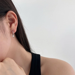 Close-up of S925 sterling silver hoop earrings with rectangular geometric zircon pendant