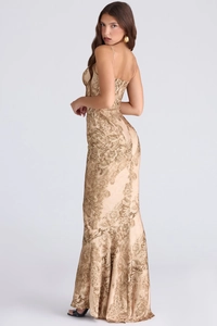 Side view of floral fishtail maxi dress featuring gold floral pattern and slender straps