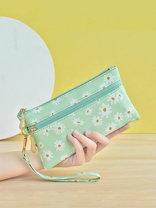 Minimalist light green daisy print clutch bag with golden zippers and wrist strap