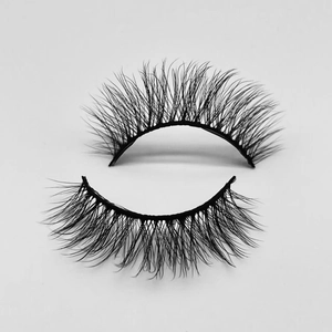 Close-up of thick, naturally curled black faux mink eyelashes with a flared fan shape
