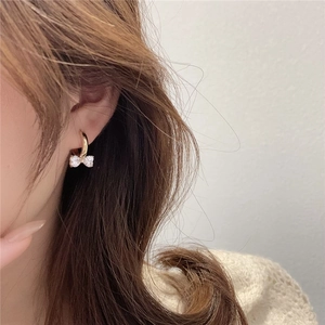 Sparkling bow-knot hoop earrings with crystals shown on a model for everyday styling