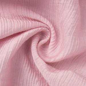 Close-up of pink pleated fabric with soft ruffled texture for summer strap top