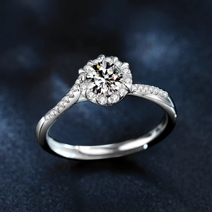 Sparkling snowflake moissanite ring in 925 sterling silver on a textured blue background