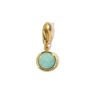 Detail view of a gold stainless steel sun pendant with light green natural stone and clasp