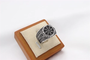 Macro view of vintage silver Viking Vegvisir ring with Norse runes and rope edge