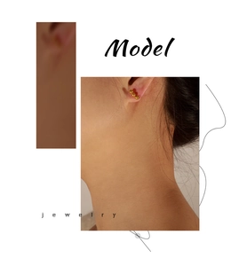 Close-up of minimalist gold titanium triple bead stud earrings worn by a female model