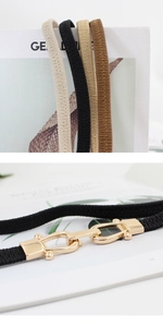 Detail of slim elastic waist belts in four colors with gold U-shape metal hook buckles