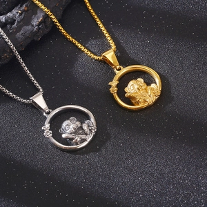 Detailed view of silver and gold panda pendants inside circles on metal chains