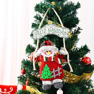 Detailed plush snowman ornament with Feliz Navidad sign hanging on a Christmas tree