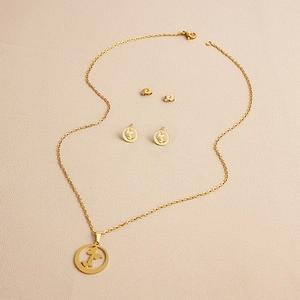 Detailed view of gold plated stainless steel butterfly necklace and matching stud earrings