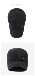 Detailed view of dark grey tweed baseball cap with sports metal badge and thick texture