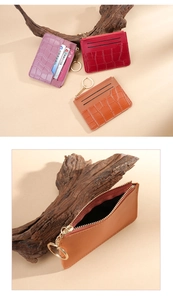 Detail of crocodile embossed faux leather card holder with zipper pocket and key ring