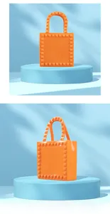 Close-up of bright orange PVC jelly tote bag with pyramid studs on a blue display stand