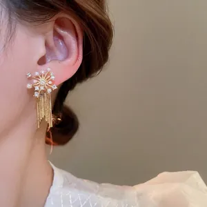 Elegant gold fireworks tassel earrings with sparkling zircon and pearls for a luxury look