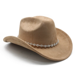 Detail of camel suede cowboy hat with sparkling diamond chain and curved brim