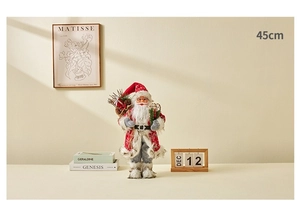 Detail of 45cm Santa Claus doll figurine standing on a desk in a warm home setting