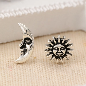 Detailed view of vintage silver sun and moon face earrings with antique metal finish