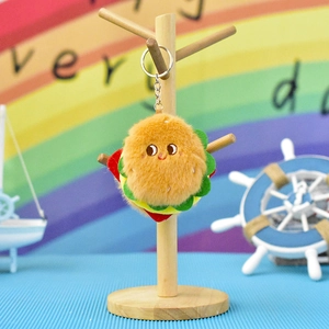 Detailed view of cute plush hamburger keychain hanging on a wooden stand