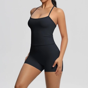 Detail of black cross-back yoga tank top showing elastic strap design and premium fabric