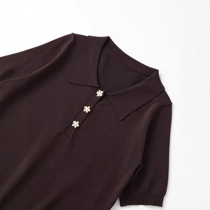 Brown short sleeve knit polo shirt with decorative white flower buttons on a white background