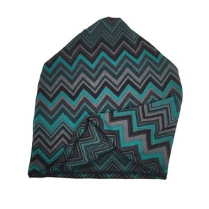 Detail of wave-patterned knit beanie with teal, grey, and black zigzag weave texture