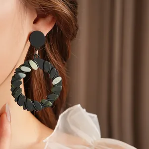 Bohemian large hoop earrings with black alloy base and green resin oval stone details