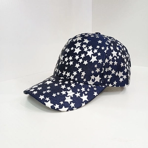 Navy blue baseball cap with white star prints and curved brim seen from a 45-degree angle