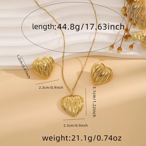 Detailed product dimensions for gold heart necklace and earring set on textured surface