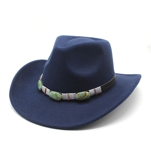 Detail of dark blue felt cowboy hat featuring vintage band with green marble stones