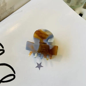 Small acetate hair claw clip with brown amber marble pattern and gold French lettering