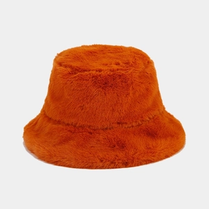 Detail of soft orange faux fur bucket hat showing high-quality plush texture and vibrant color