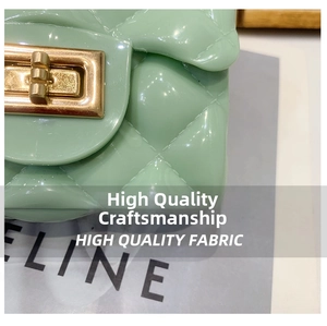 Macro detail of mint green jelly bag featuring quilted texture and gold turn-lock closure