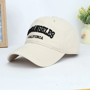 Detailed close-up of Los Angeles 3D embroidery on a beige cotton baseball cap