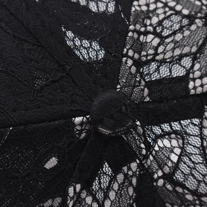 Detailed view of the black floral lace fabric and top button on the breathable baseball cap