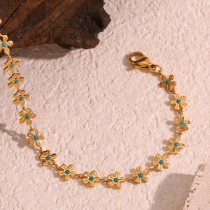 Detail of 18K gold-plated flower bracelet with sky blue enamel and secure lobster clasp