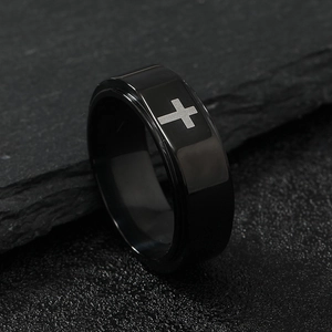 Detailed close-up of a black stainless steel ring featuring a matte cross pattern design